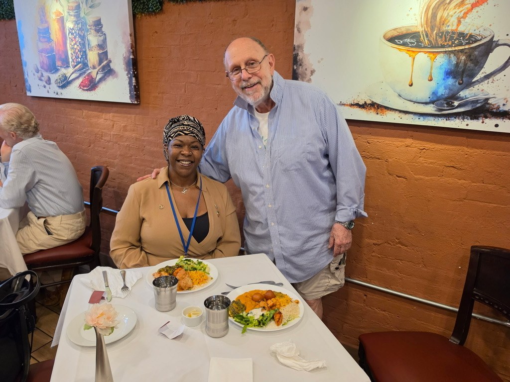 Dr. Lakisha and Paul Sladkus of Good News Planet at a restaurant table