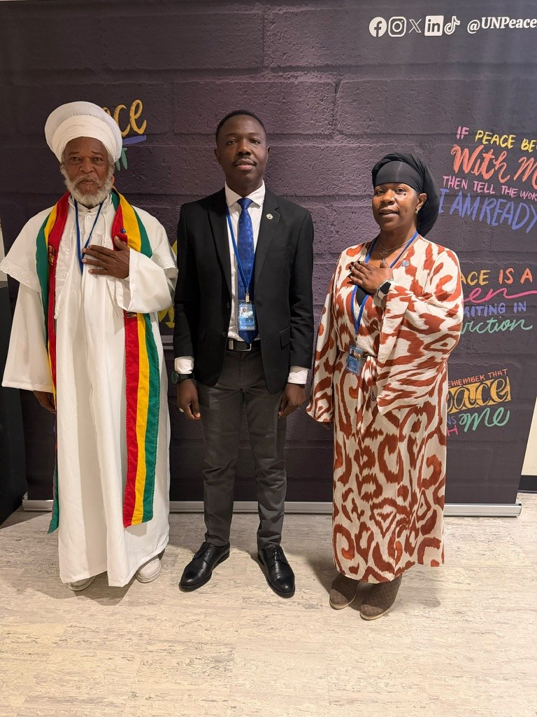 Dr. Lakisha with two attendees against a United Nations peace backdrop
